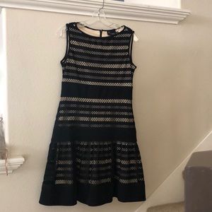 Crocheted black dress with flounce skirt.